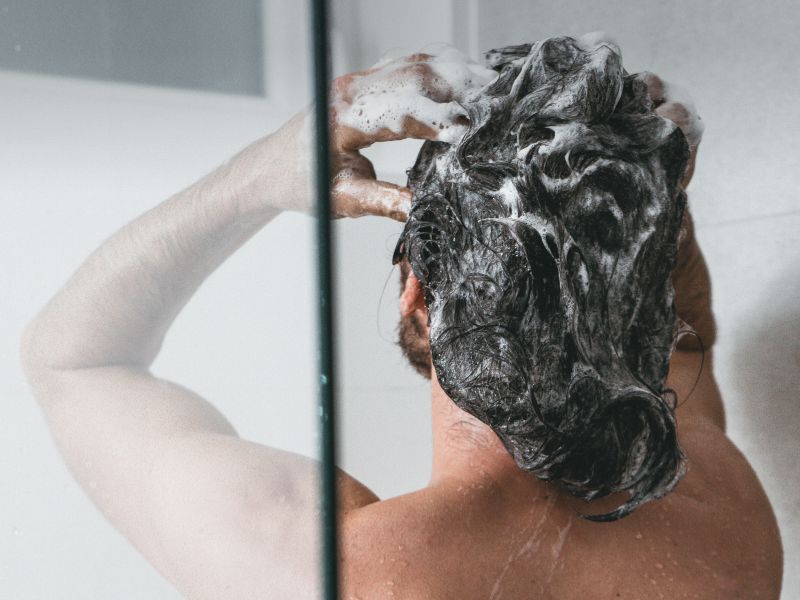 A back view of a woman taking a shower