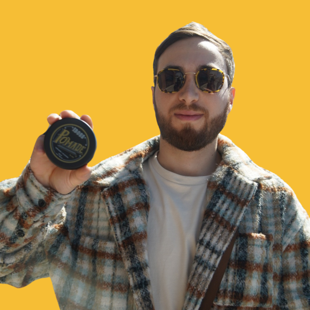 a man holding an iboss pomade gel