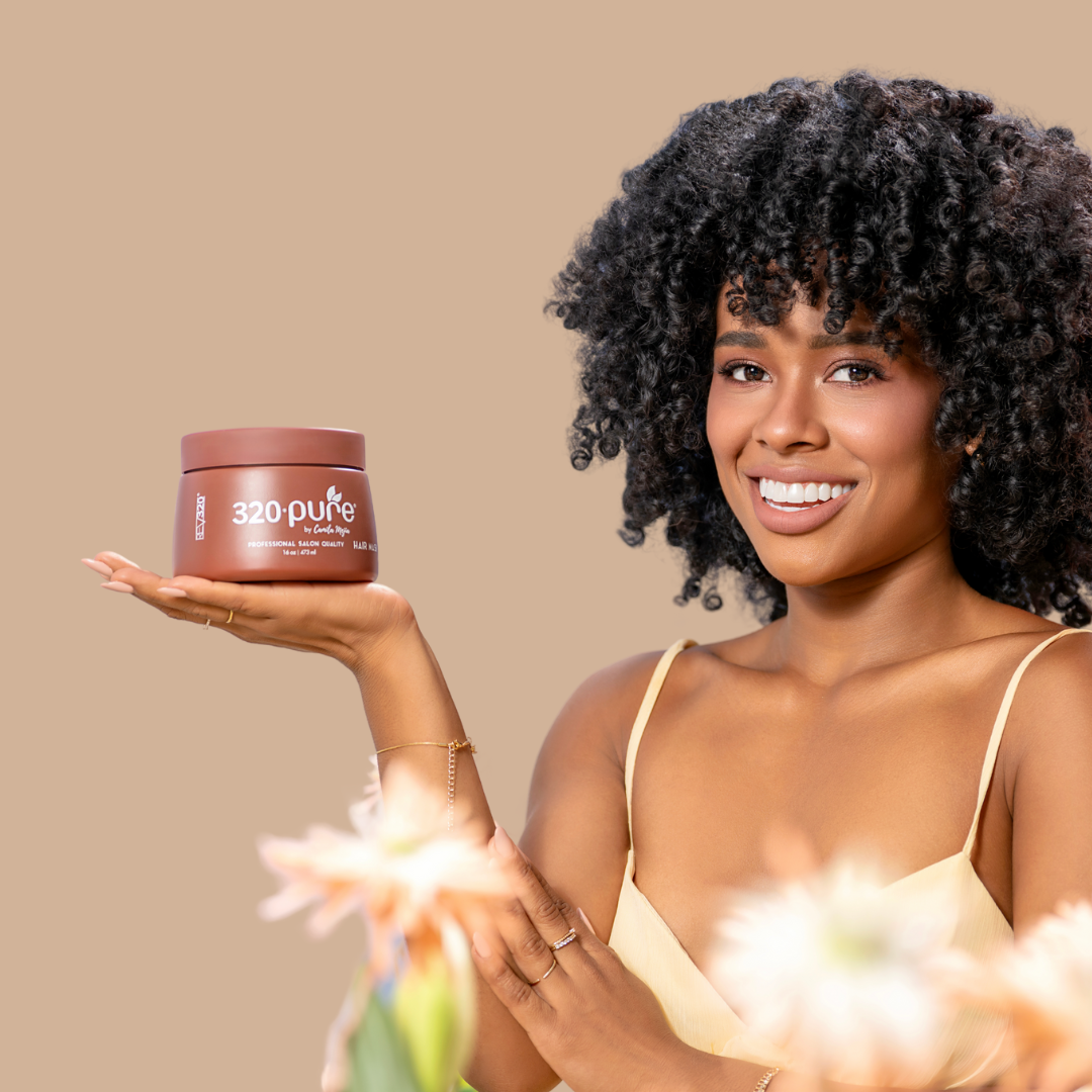A woman holding a 320 Pure hair mask to her palm