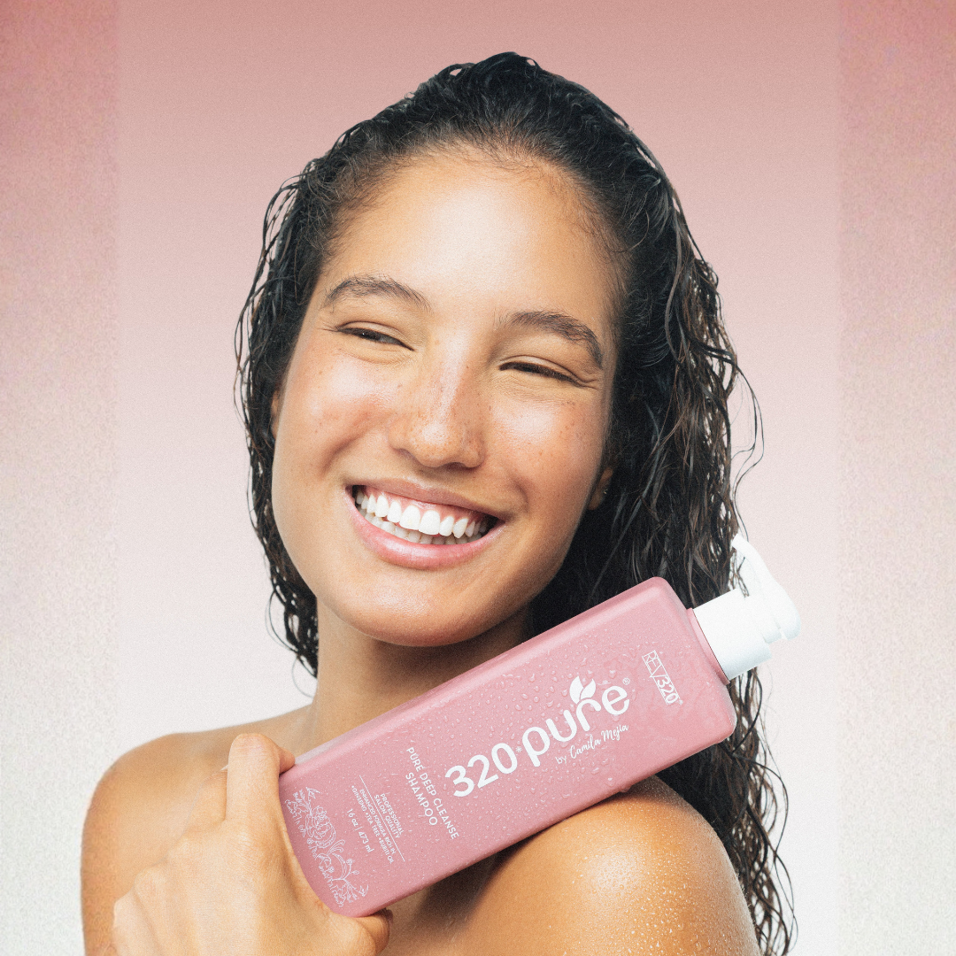 Woman holding 320 Pure Deep Cleansing Shampoo from REV320