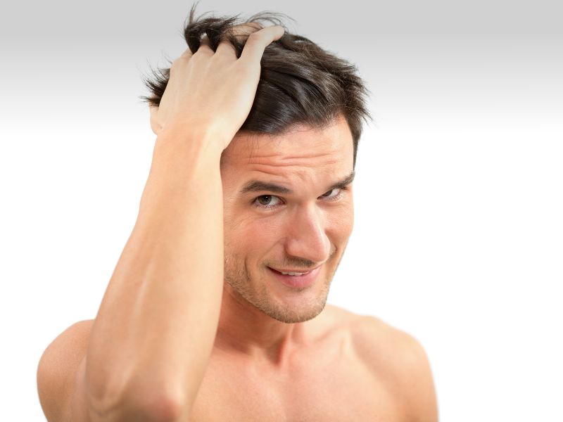 A man styling his hair with pomade