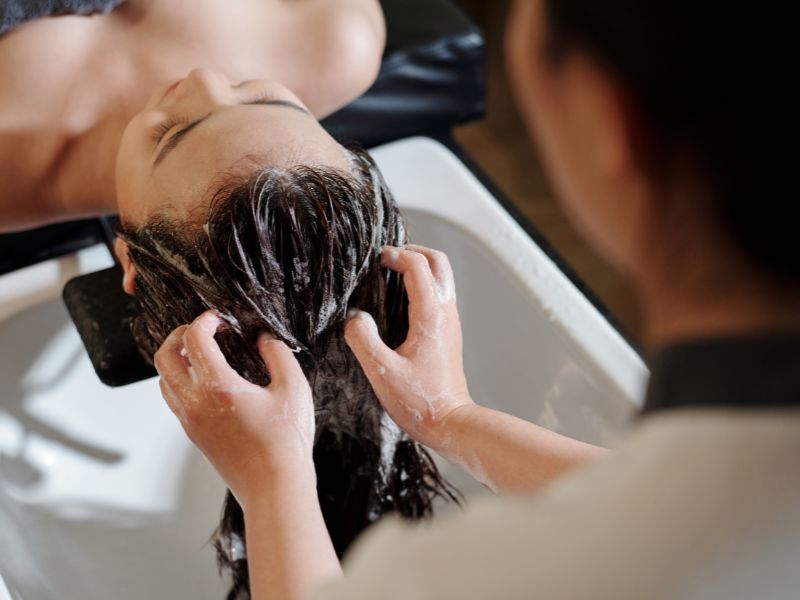 A woman having a deep conditioning in the salon