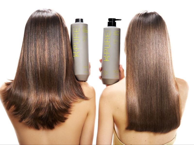 A back view of two women holding K Pure products