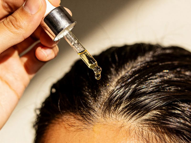 Applying Hair Serum Dropper on the Scalp