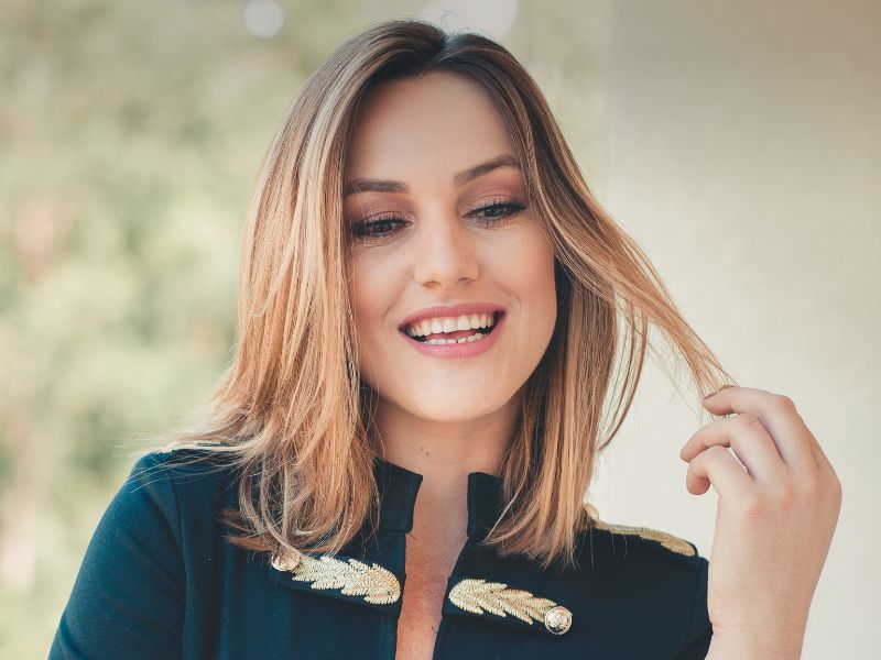 A happy woman twisting the end of her hair