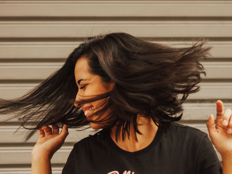 A happy woman waving her hair