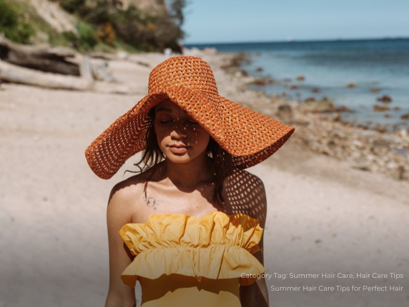 A Woman Wearing a Hat at the Beach