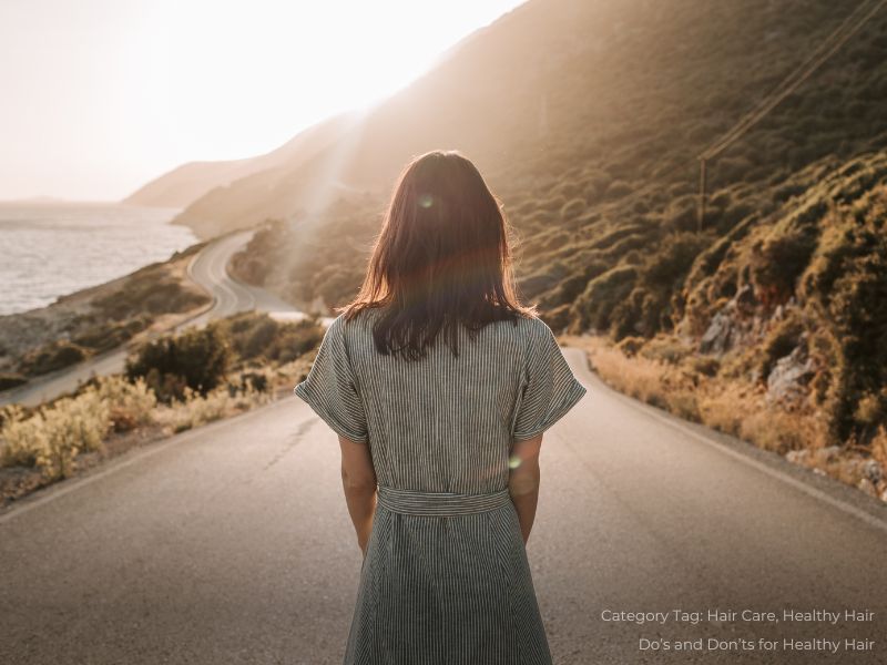 Woman in Blue and White Dress Standing In The Middle Of A Road
