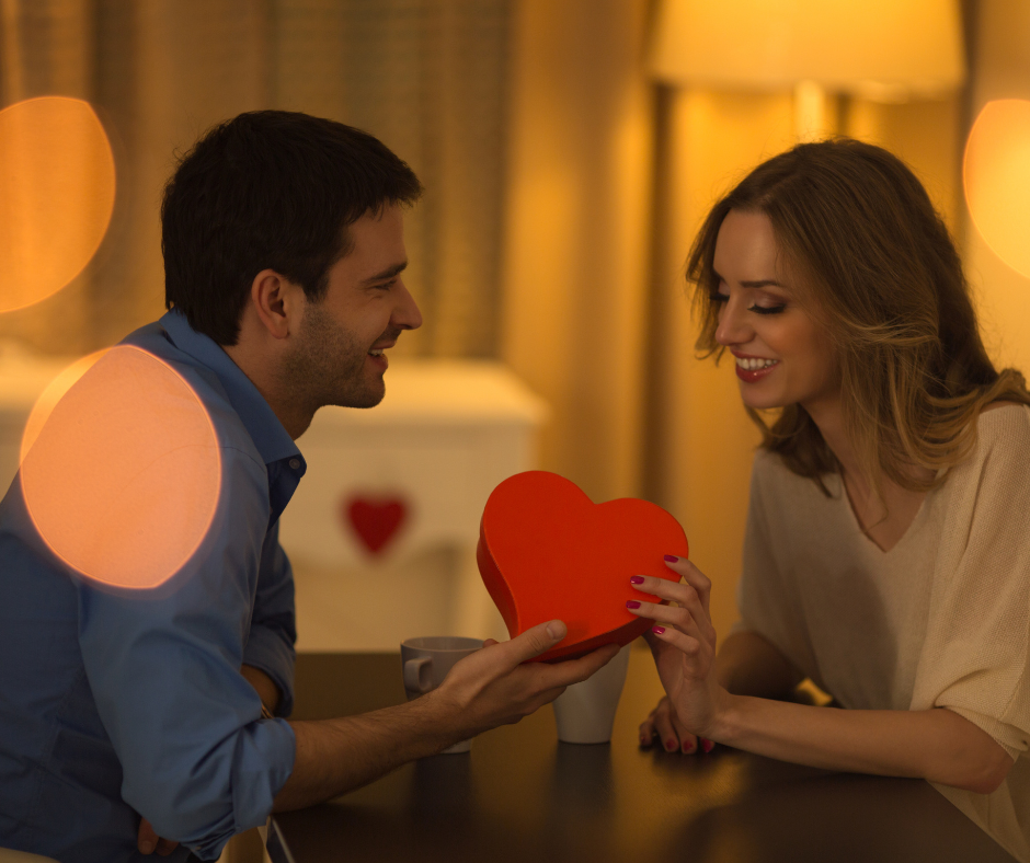 man giving a heart gift to a woman