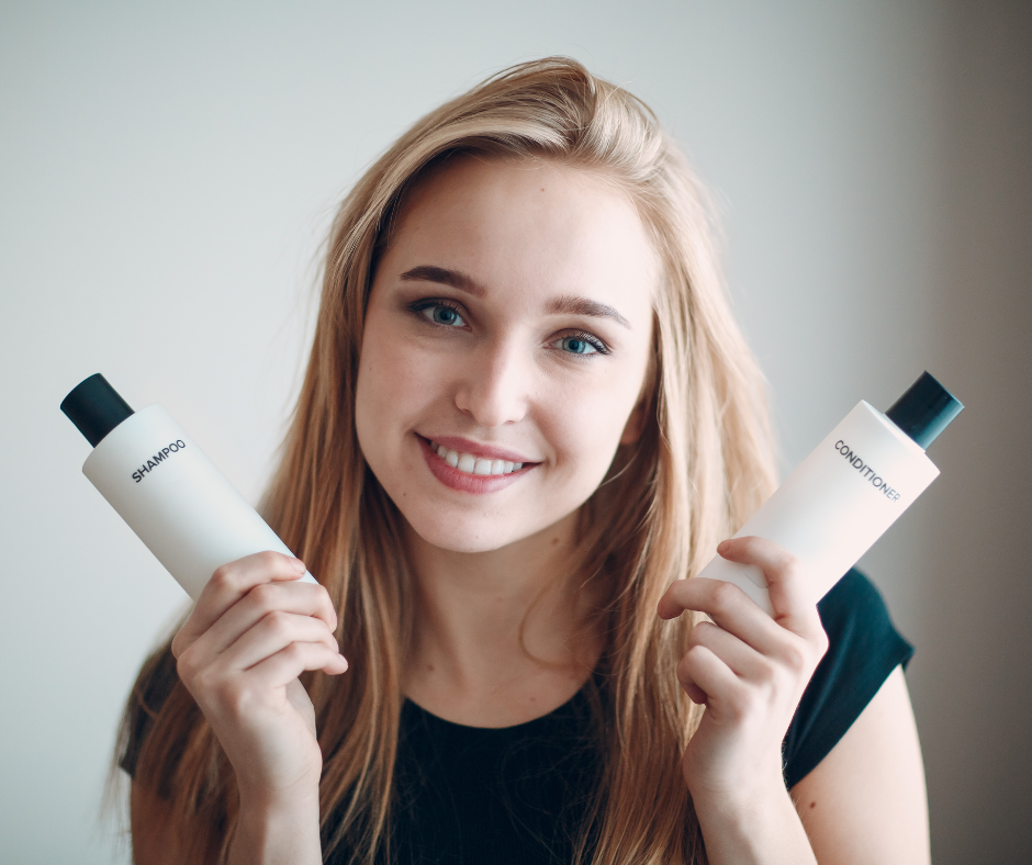 woman holding shampoo and conditioner