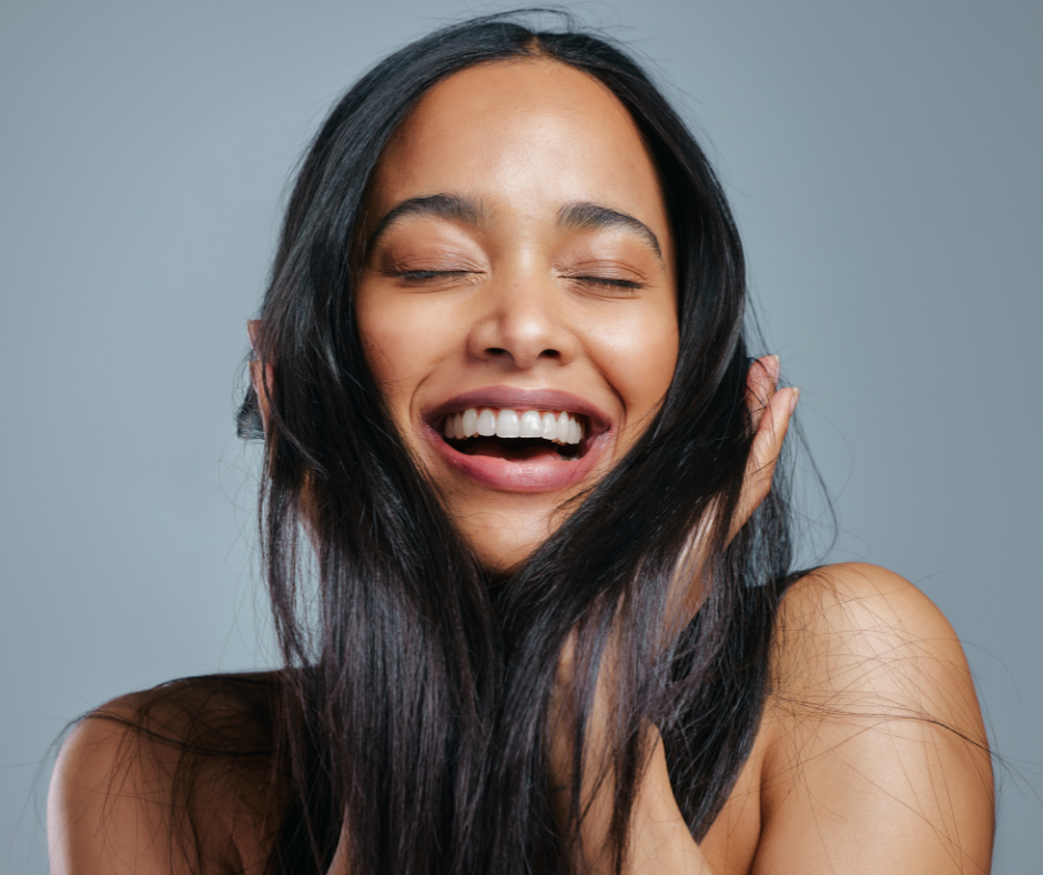 woman happy while touching her hair