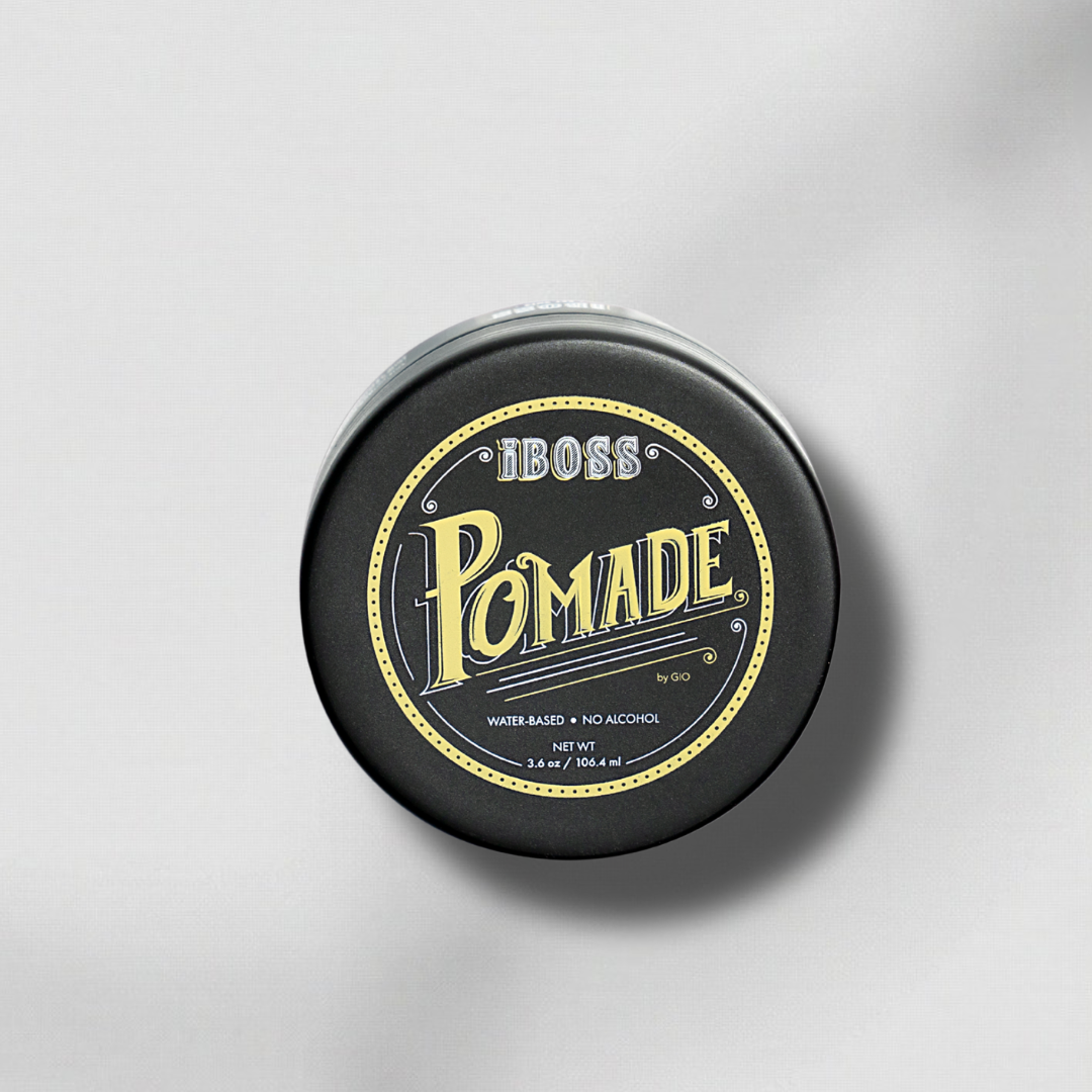 Black container of iboss pomade with gold text on a gray background